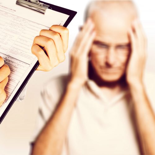 Mature man having headache and doctor